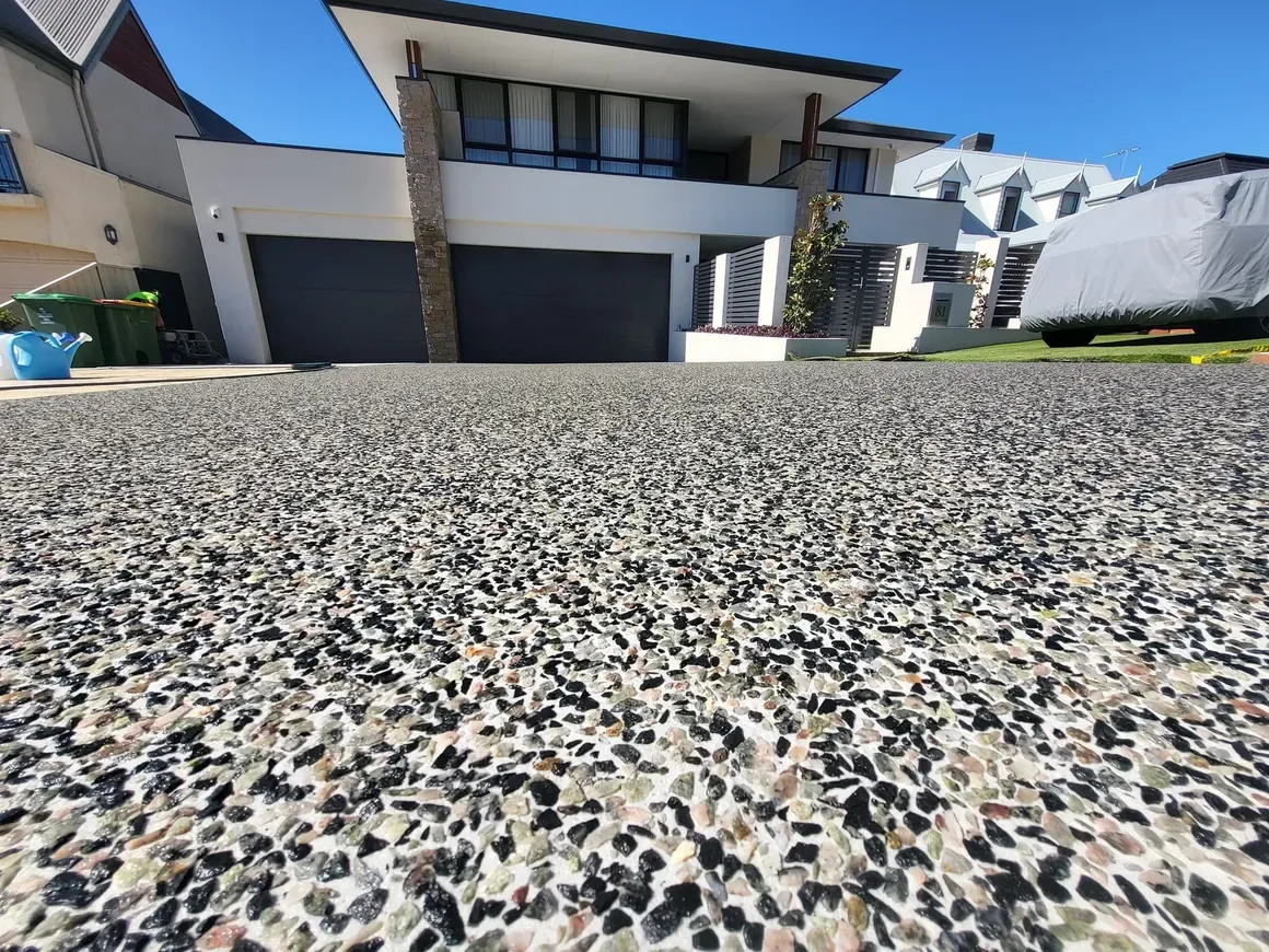 Exposed aggregate concrete finish with decorative stone texture